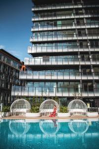 a building with a swimming pool in front of a building at SKYE Suites Green Square in Sydney