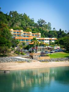 een hotel aan de oever van een waterlichaam bij Shingley Beach Resort - Whitsundays in Airlie Beach