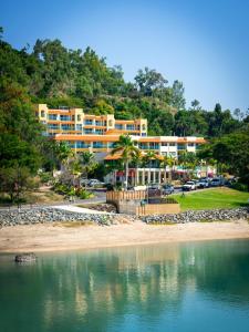 a hotel on the shore of a body of water at Shingley Beach Resort - Whitsundays in Airlie Beach