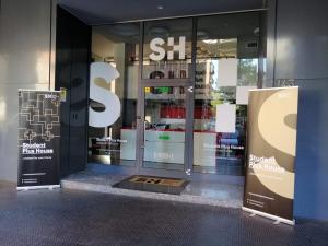 a store front with a large sign in the window at SPH Hotel in Turin