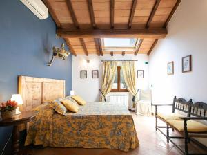a bedroom with a bed and a table and a window at Villa Santa Chiara in Siena