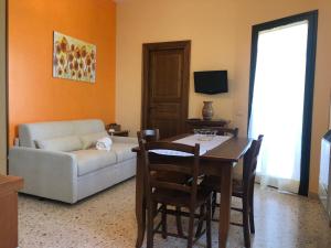 a living room with a table and a couch at Bono Vacanze Villa Maragani Charme & Relax in Sciacca