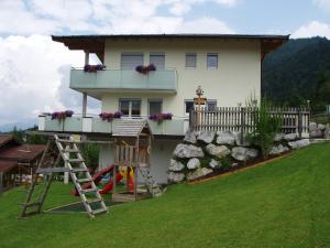 a house with a playground in front of it at Appartement Wohlfartstätter in Walchsee