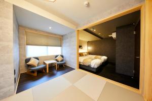 a bedroom with a bed and a desk and a chair at Rinn Shijo Nishinotoin in Kyoto