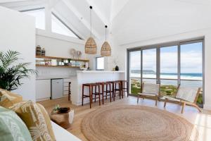 a kitchen and living room with a view of the ocean at Cape Beach Villa in Noordhoek