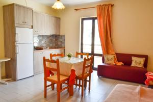 a kitchen and dining room with a table and chairs at Amaryllis Hotel in Karpathos
