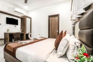 Una habitación de hotel con una cama con cisnes. en Hotel Kings, en Amritsar
