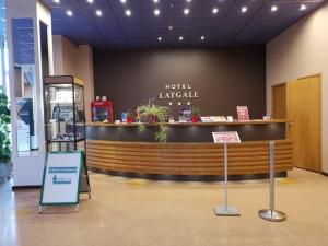 a hotel lobby with a reception counter in a building at Latgale in Rēzekne