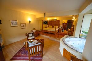 a room with a bath tub and a bedroom at Mandarin & Mango Boutique Hotel in Faralya