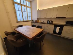a large kitchen with a wooden table and chairs at Le Bijou BK9 Presidential Suite in Bern