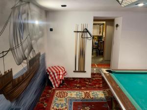 a living room with a pool table and a rug at Pension Lehmann in Köthen