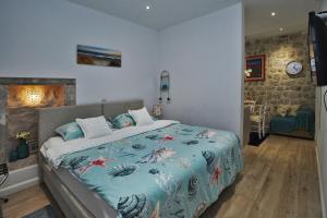 um quarto com uma cama com um edredão azul em L & L Old Town Apartments em Dubrovnik