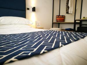 Letto o letti in una camera di Hotel Rombino