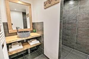 a bathroom with a sink and a shower at Chalet L'Ecureuil in Peisey-Nancroix