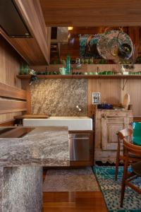 a kitchen with a marble counter top and wooden walls at Vis à Vis in Nieuwpoort +10 photos