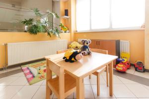 a table with two stuffed animals sitting on top of it at Invest Vendégház in Eger