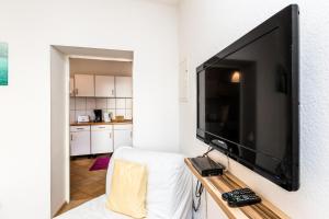 a living room with a flat screen tv on a wall at Workers Apartment Troisdorf Spich in Spich
