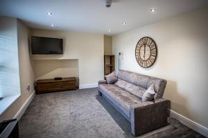 a living room with a couch and a flat screen tv at Caernarfon Apartments in Caernarfon