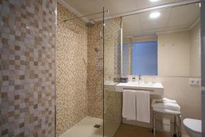 a bathroom with a shower and a sink and a toilet at Hotel Cap Negret in Altea