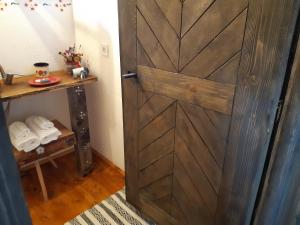 a wooden door in a room with a table at Iz de Maramures Rural Hotel in Şurdeşti +73 photos