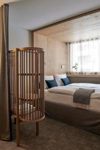 a bedroom with a bed with a crib in it at Carina - Design&Lifestyle hotel in Zermatt