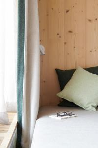 a bed with a pair of glasses sitting on it at Carina - Design&Lifestyle hotel in Zermatt