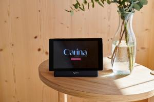 a laptop sitting on a table next to a vase at Carina - Design&Lifestyle hotel in Zermatt