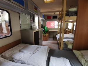 a small room with a bed and a bunk bed at Treck Hostel in Ghent