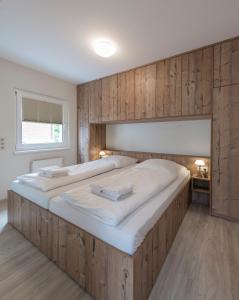 クックスハーフェンにあるHaus Pamir _ Fewo 21の木製の壁の客室の大型ベッド1台