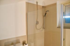 a bathroom with a shower and a sink at BeachFront Rooms Marina di Ragusa in Marina di Ragusa +32 photos