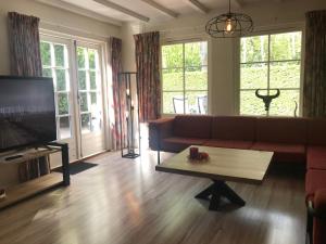 a living room with a couch and a coffee table at De Specht in Bergen