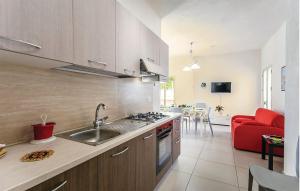 a kitchen with a sink and a stove top oven at Villa Rosso Corallo in Punta Secca