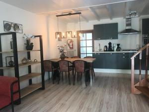 cocina y comedor con mesa y sillas en De Specht en Bergen