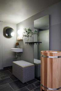 a bathroom with a sink and a mirror at Carina - Design&Lifestyle hotel in Zermatt