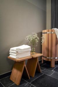 a stack of towels sitting on top of wooden tables at Carina - Design&Lifestyle hotel in Zermatt