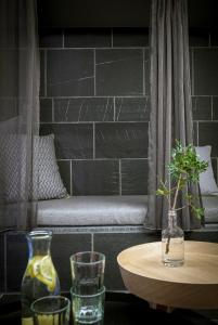a table with two vases and a table with a bench at Carina - Design&Lifestyle hotel in Zermatt
