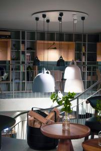 a room with a table and chairs and pendant lights at Carina - Design&Lifestyle hotel in Zermatt