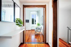 an open hallway with a door leading to a living room at Butterfly Apartment in Rapallo