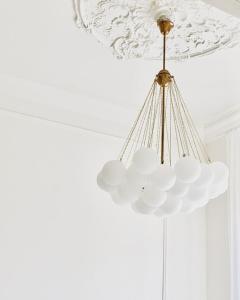 una lámpara de araña colgando del techo de una habitación en Glamour apartment en Liepāja