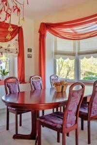 a dining room with a wooden table and chairs at Vineyard Country House with Panoramic Seaview in Alexandroupoli