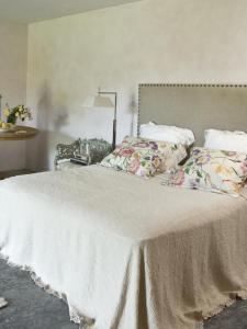 a white bed with pillows and a lamp on it at Villa Romana in Campagnano di Roma