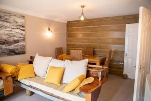 a living room with a couch and a wooden wall at The Beach House in Eastbourne