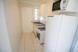 Il comprend une petite cuisine équipée d'un réfrigérateur et d'un four micro-ondes. dans l'établissement Residencial Neide Maria, à Bombinhas