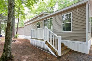 a house with a white staircase on the side of it at Moody Beach Camping Resort Loft Park Model 14 in Moody