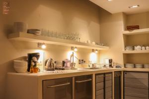 a kitchen with a sink and a counter top at Villa Zawaia B&B in Lagos