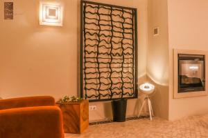 a room with a chair and a wall with a window at Villa Zawaia B&B in Lagos