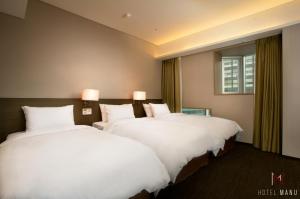 Postelja oz. postelje v sobi nastanitve Hotel Manu Seoul