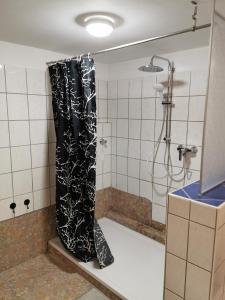 una doccia con tenda nera in bagno di Apartment Seascape - Self Check-In a Duisburg Altre 32 foto