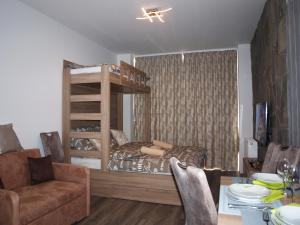 a living room with a bunk bed and a table at Orion in Starý Smokovec