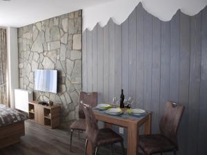 a dining room with a table and chairs at Orion in Starý Smokovec